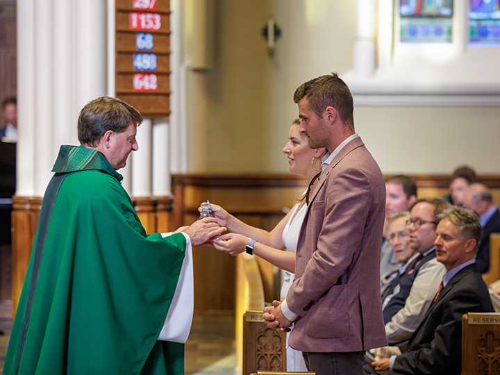 ACE graduates present the offertory gifts to Fr. Lou DelFra, CSC 