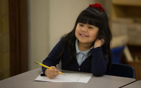 Student girl smiling at desk