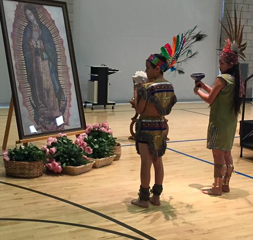 Students at St. Andrew School in Salt Lake City, UT, dress in indigenous clothing and present gifts to La Virgencita.