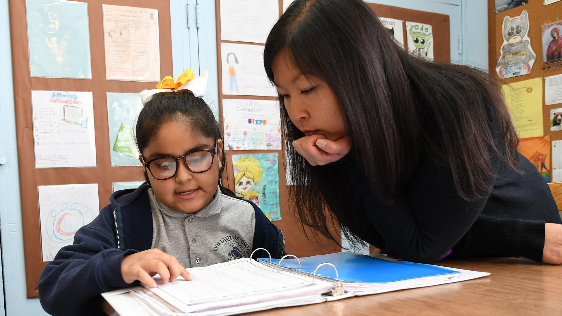 Teacher with girl reading