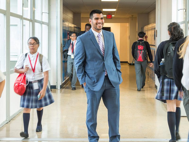 Latino man smiling in school hallway