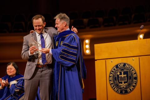 Dan Reynold receiving the Michael Pressley Award for Most Promising Scholar from John Staud